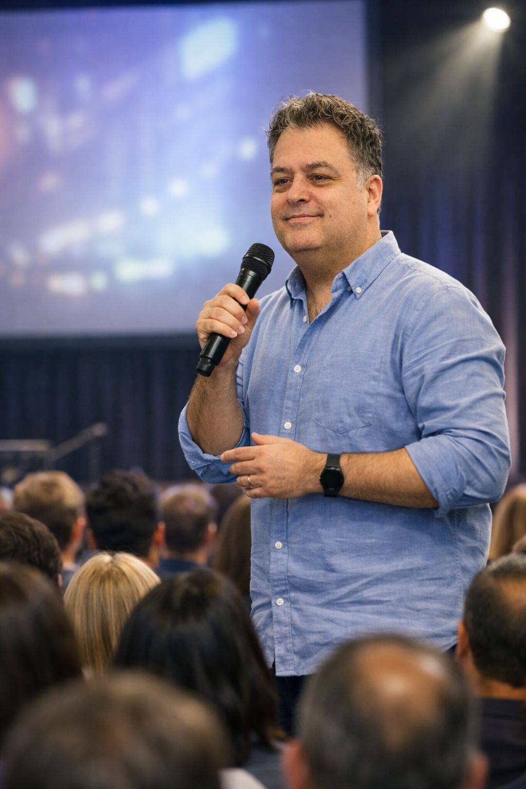 Jonathan Ressler holding a microphone and speaking directly to people in a live audience about personal responsibility and choice